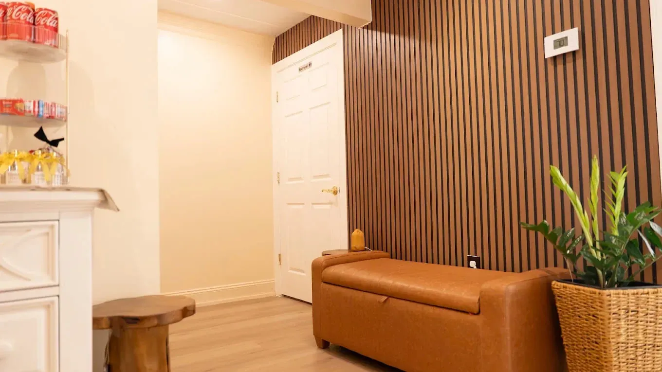 A massage lounge with chairs and warm lighting