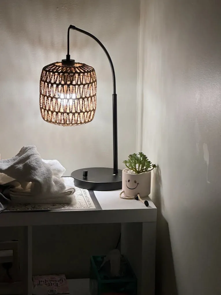 Folded towels and a lamp beside a massage table at Crystal Massage in Wichita