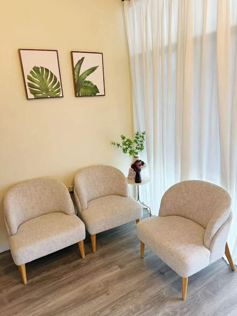Cream armchairs in the waiting area at Crystal Massage